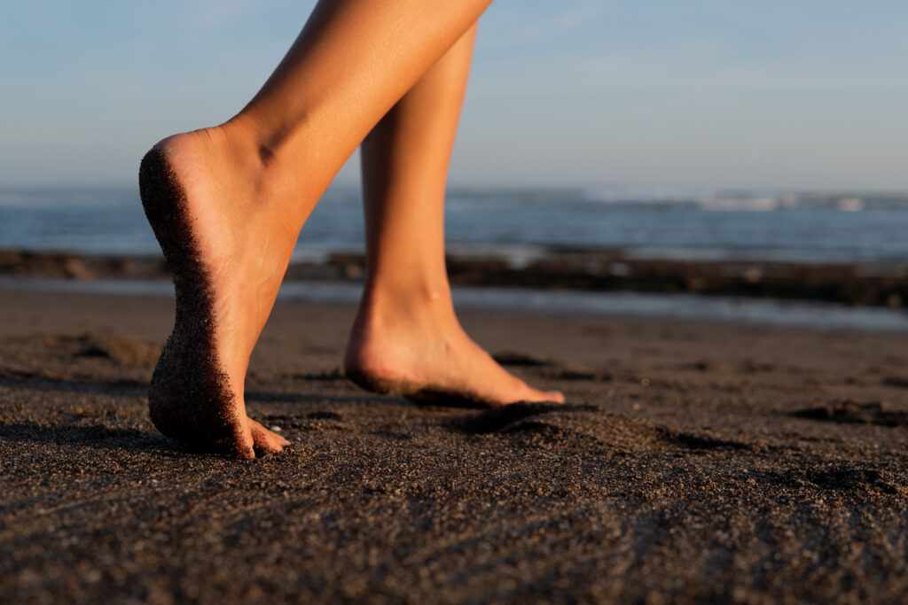 close up. feet on black sand